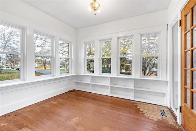 unfurnished sunroom with plenty of natural light