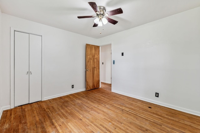 unfurnished bedroom featuring a closet, light hardwood / wood-style floors, and ceiling fan