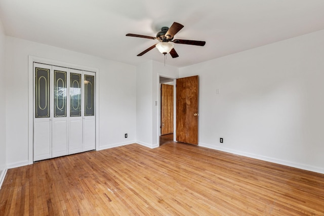 unfurnished bedroom featuring ceiling fan, light wood-type flooring, and a closet