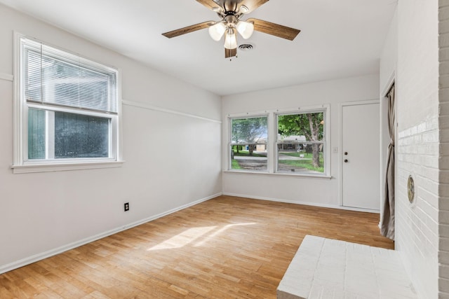 empty room with ceiling fan and light wood-type flooring