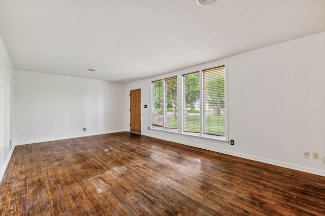 spare room with hardwood / wood-style floors