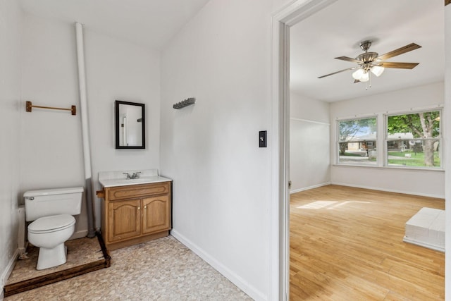 bathroom featuring vanity, hardwood / wood-style flooring, toilet, and ceiling fan