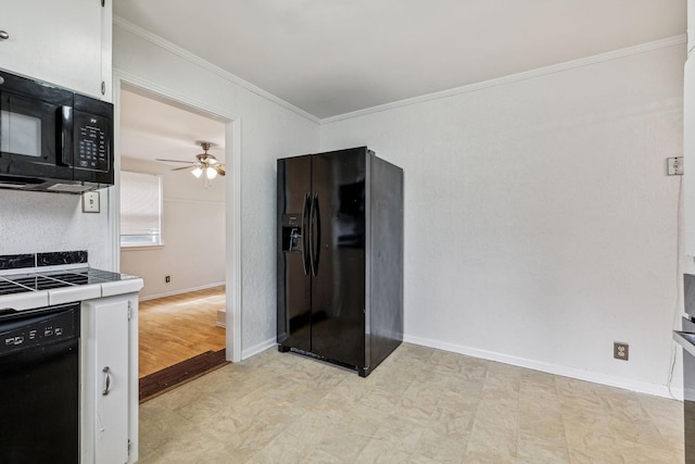 kitchen with white cabinetry, tile counters, ceiling fan, black appliances, and ornamental molding