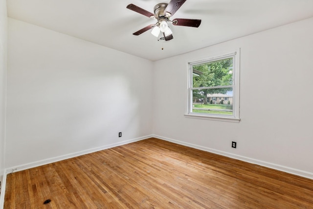 spare room with hardwood / wood-style floors and ceiling fan