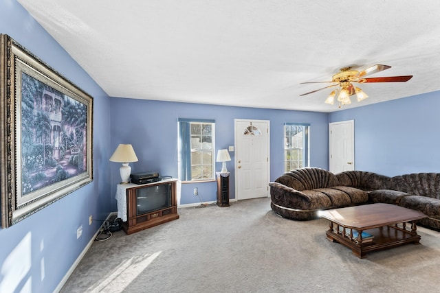 carpeted living room featuring ceiling fan