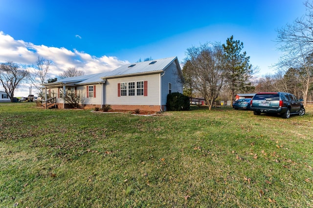 view of side of home featuring a yard