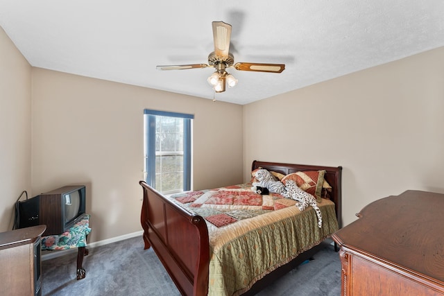 bedroom with ceiling fan and dark colored carpet