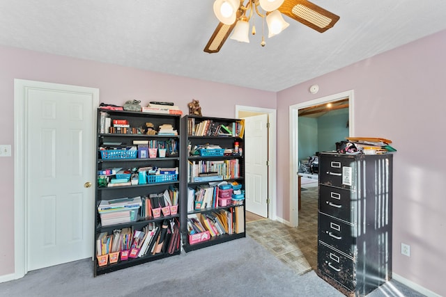 interior space featuring carpet, ceiling fan, and a textured ceiling