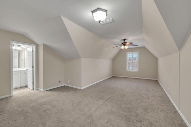 bonus room with ceiling fan, light colored carpet, and lofted ceiling