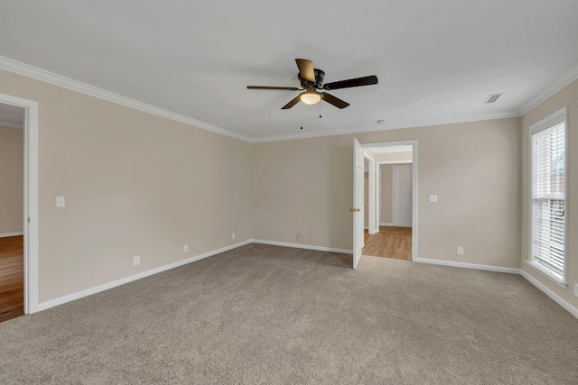 carpeted empty room featuring ceiling fan and crown molding