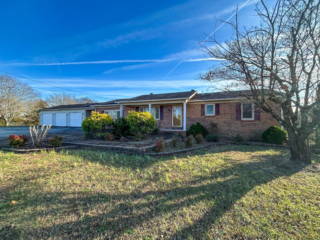 ranch-style home with a front lawn and a garage