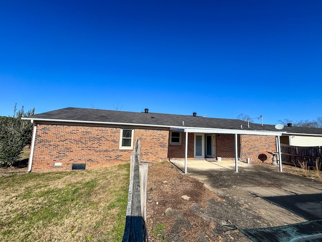 rear view of property featuring a patio area and a yard