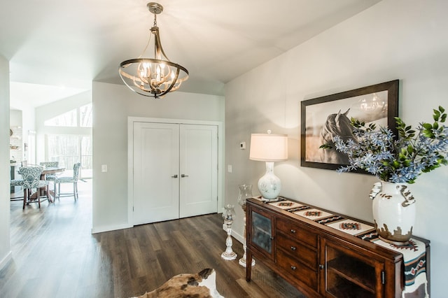 entrance foyer featuring a notable chandelier and dark hardwood / wood-style flooring