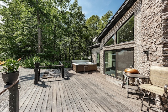 wooden deck with a hot tub