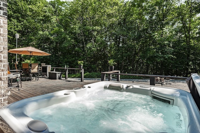 view of swimming pool featuring a wooden deck and an outdoor hot tub