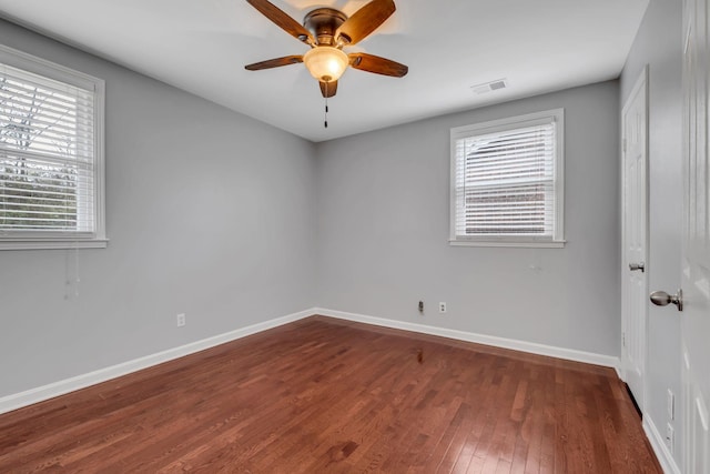 empty room featuring dark hardwood / wood-style floors and ceiling fan