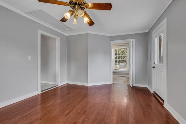 spare room with ceiling fan, dark hardwood / wood-style flooring, and crown molding