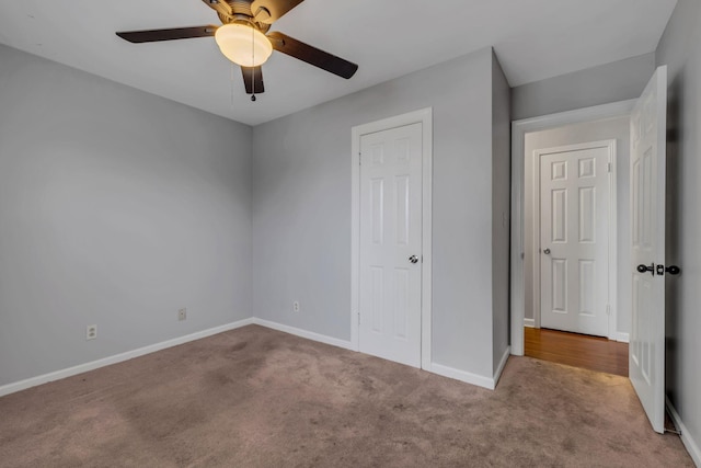 unfurnished bedroom featuring ceiling fan and light carpet