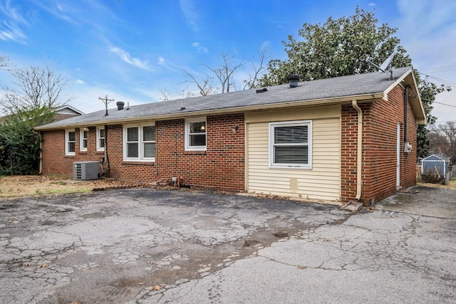 rear view of property featuring central AC unit