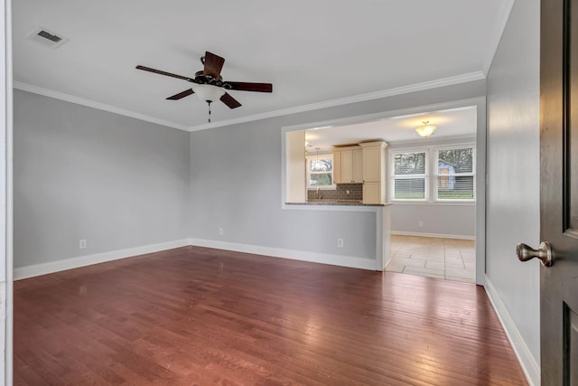 unfurnished room with ceiling fan, dark hardwood / wood-style flooring, and ornamental molding