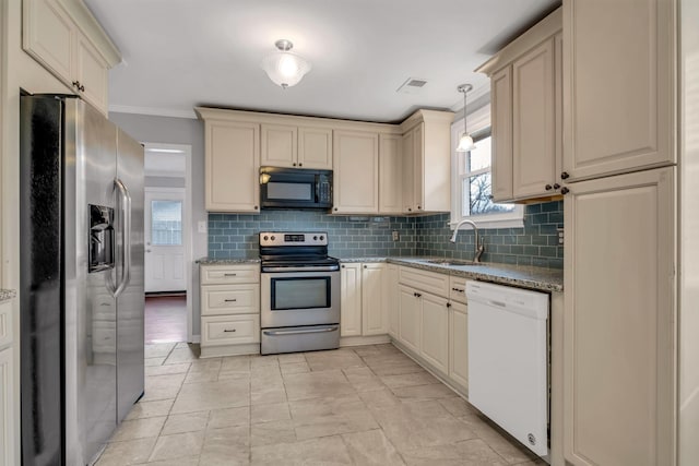 kitchen featuring stone counters, sink, pendant lighting, appliances with stainless steel finishes, and ornamental molding