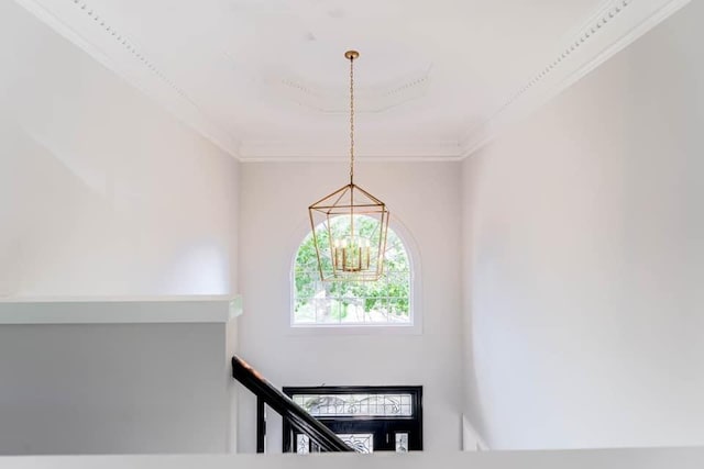 stairs featuring an inviting chandelier and crown molding