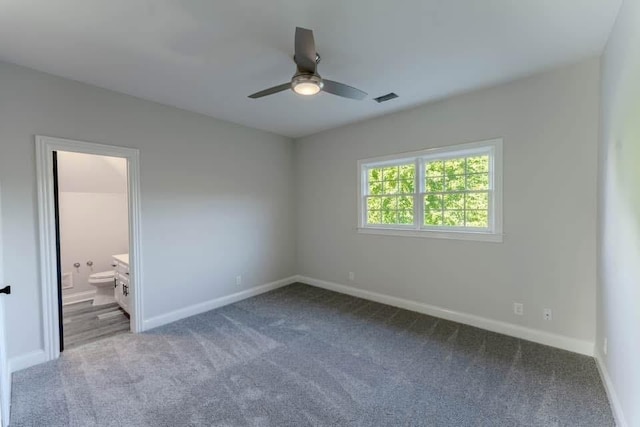 unfurnished bedroom with carpet flooring, ceiling fan, and ensuite bathroom