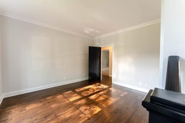 unfurnished room with dark hardwood / wood-style floors and ornamental molding