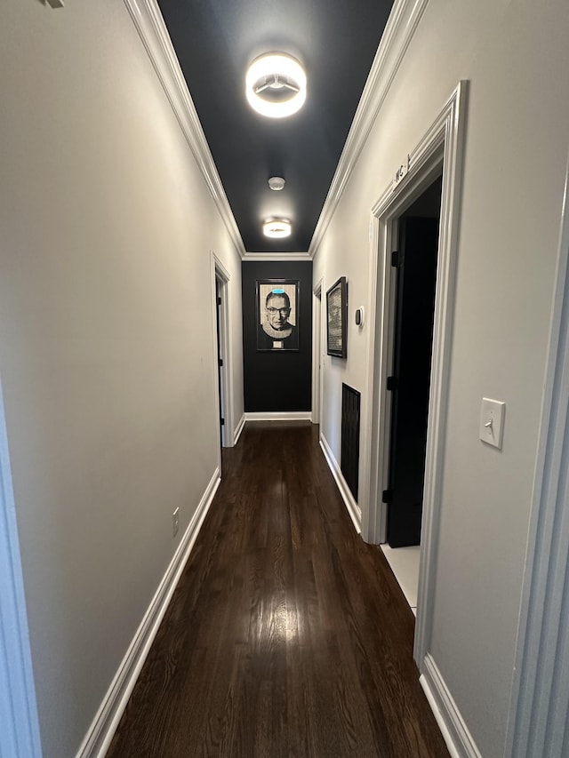 hall featuring crown molding and dark hardwood / wood-style floors