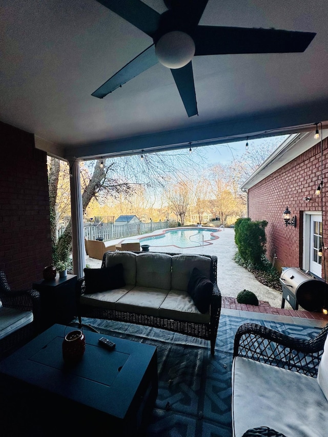 patio terrace at dusk featuring an outdoor living space and ceiling fan