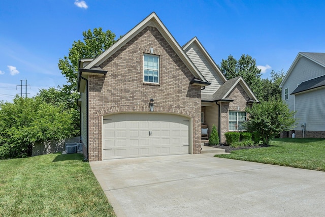 view of property featuring central air condition unit, a front yard, and a garage