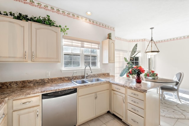 kitchen featuring cream cabinetry, dishwasher, sink, and decorative light fixtures