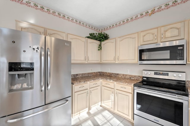 kitchen featuring appliances with stainless steel finishes and light tile patterned floors