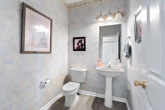 bathroom featuring tile patterned flooring, toilet, and sink