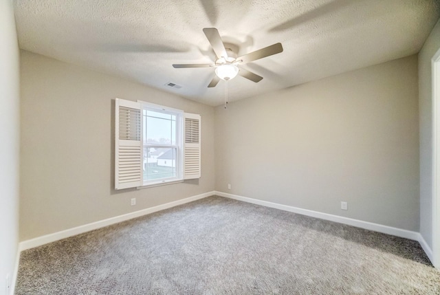 empty room with carpet floors, a textured ceiling, baseboards, and a ceiling fan