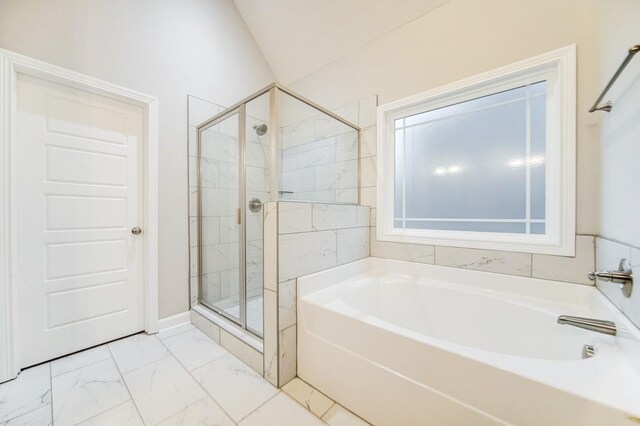 full bathroom featuring marble finish floor, a shower stall, and a garden tub