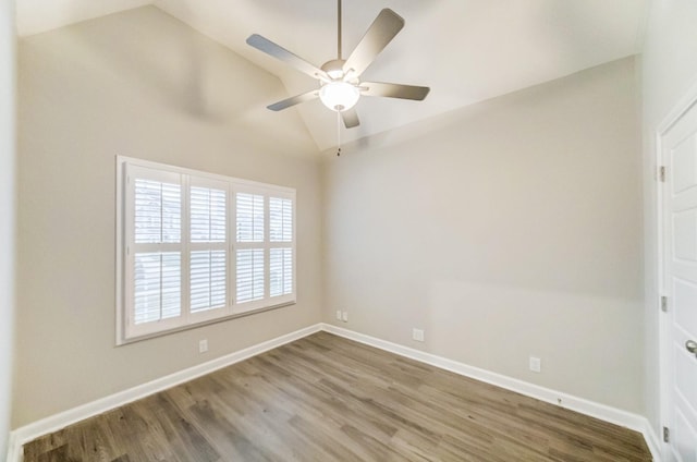 empty room featuring lofted ceiling, ceiling fan, baseboards, and wood finished floors