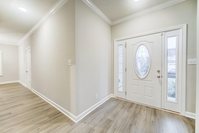 foyer with baseboards, crown molding, and light wood finished floors