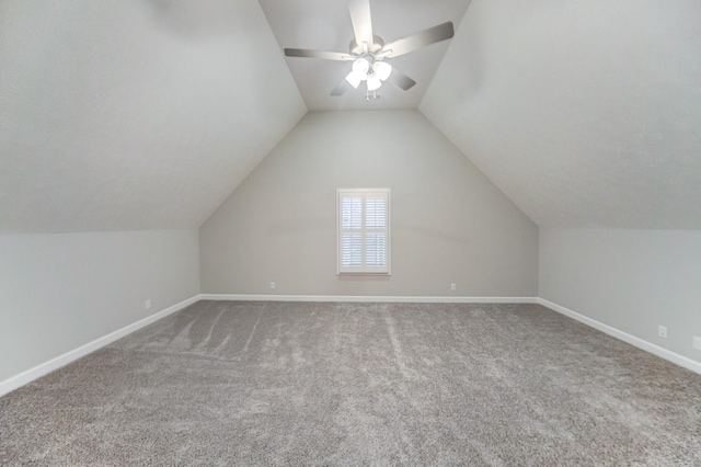 bonus room featuring carpet, vaulted ceiling, baseboards, and ceiling fan