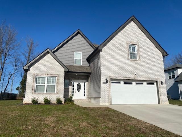 view of front of home with a garage and a front yard