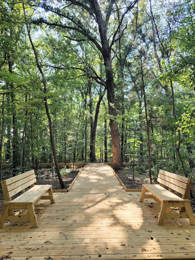 wooden deck featuring a forest view