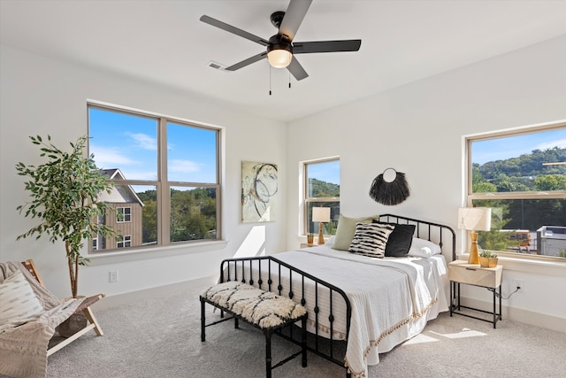 bedroom with multiple windows, carpet floors, and ceiling fan