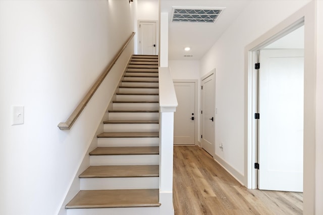 staircase featuring hardwood / wood-style flooring