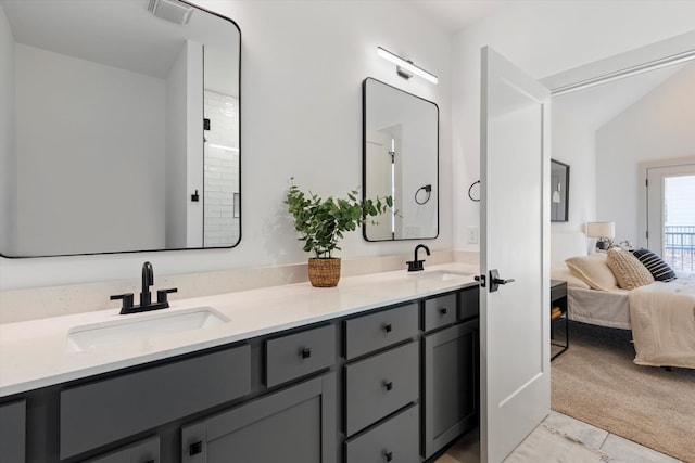 bathroom featuring tile patterned floors, vanity, and lofted ceiling