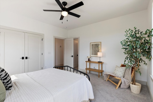 bedroom with carpet flooring, ceiling fan, and a closet