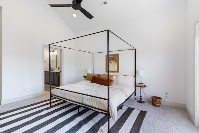 carpeted bedroom featuring ceiling fan, high vaulted ceiling, and ensuite bathroom