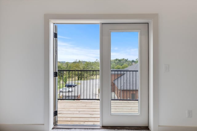 doorway to outside with hardwood / wood-style flooring and a healthy amount of sunlight