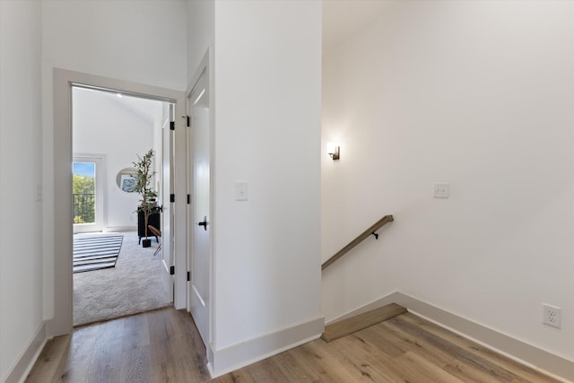 interior space featuring light hardwood / wood-style floors and lofted ceiling