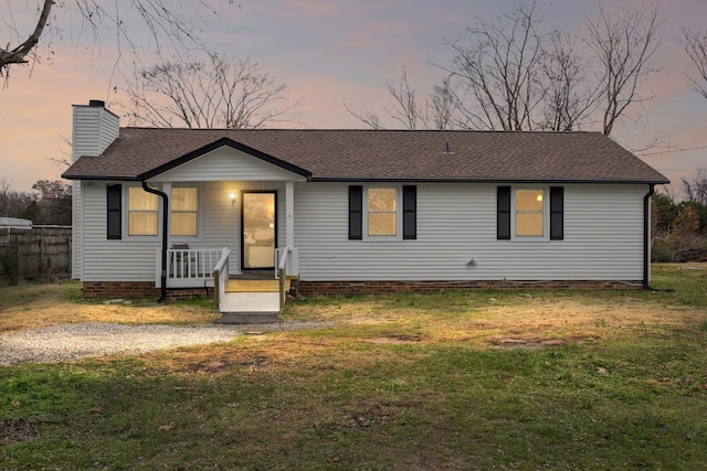 single story home with a lawn and a porch