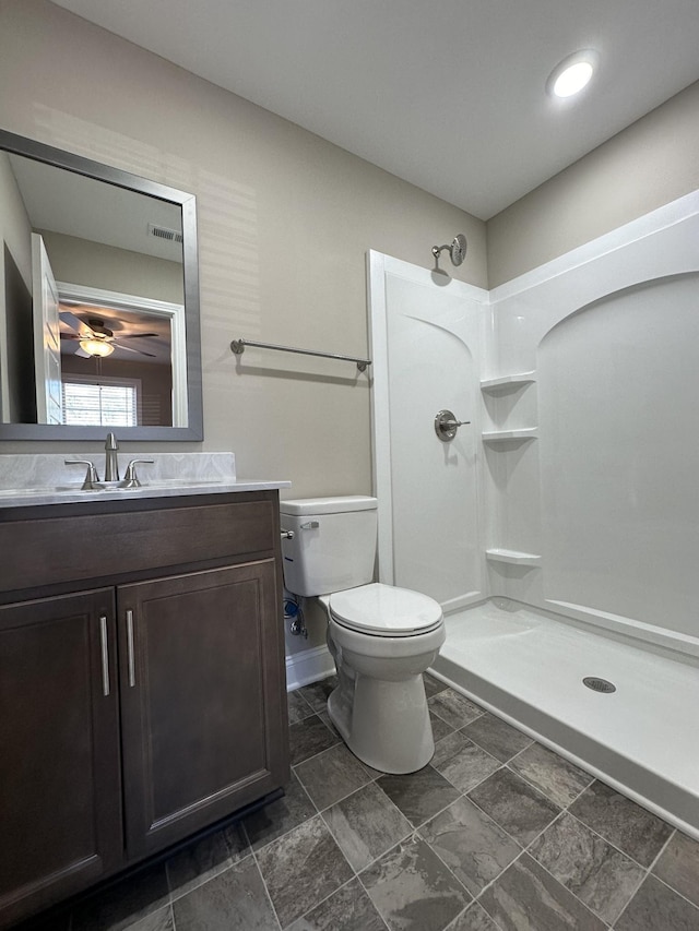 bathroom featuring vanity, toilet, and walk in shower